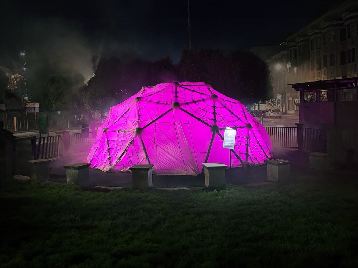 HoloDome2 glowing magenta through its parachute skin at Patricia’s Green at night