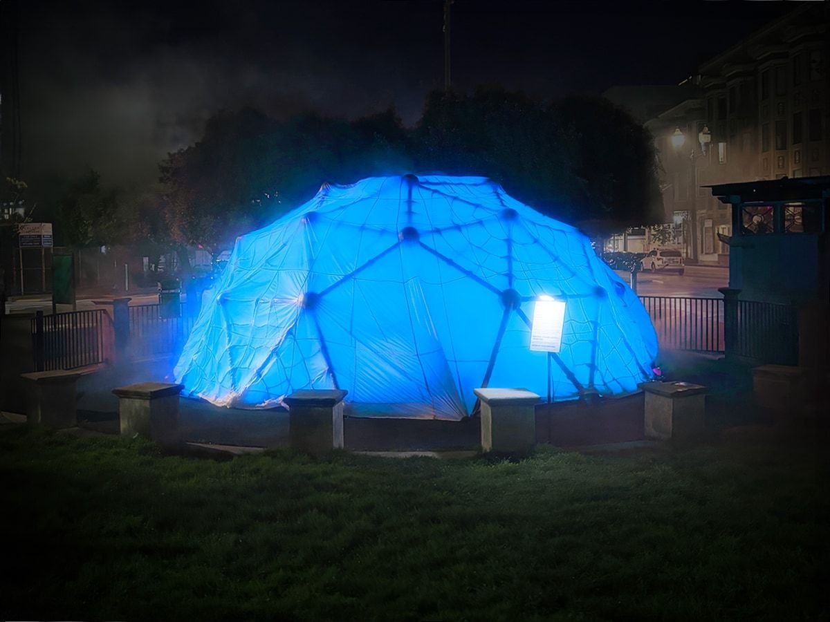 HoloDome2, the parachute-draped dome at Patricia’s Green glowing blue in the fog at night