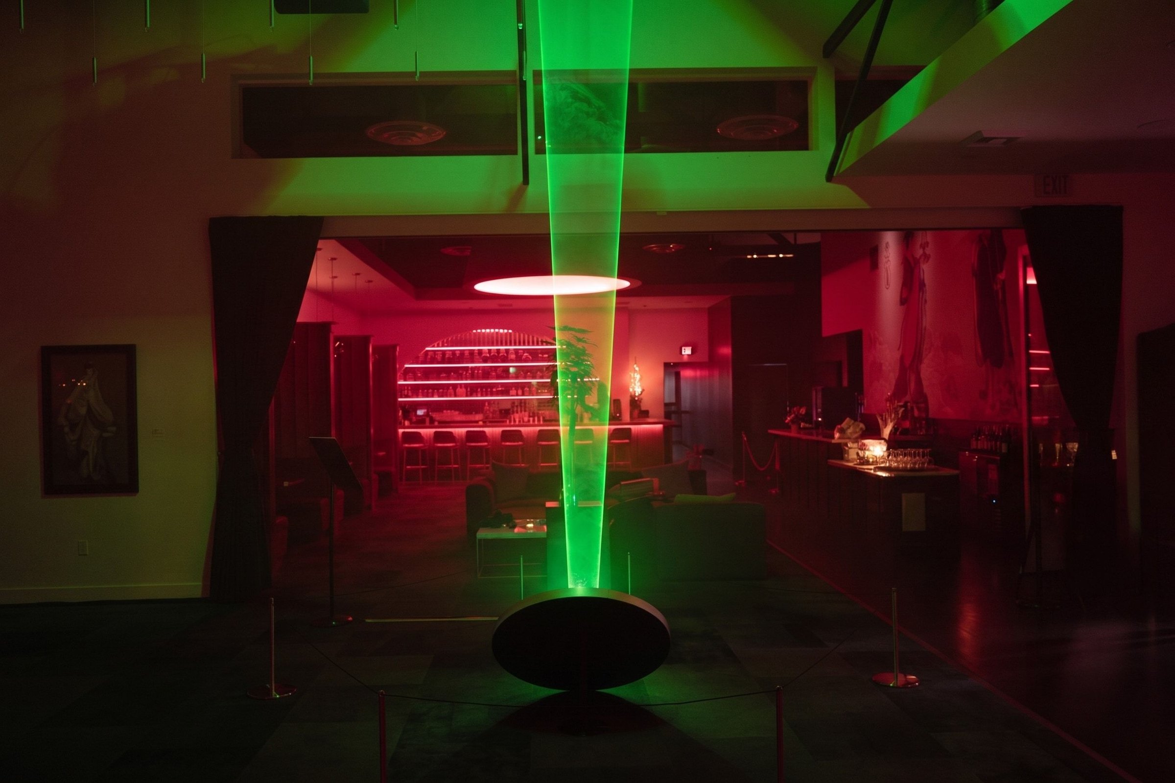 WaveGate’s green laser beam rising from the mirror on its black podium in the red-lit lounge